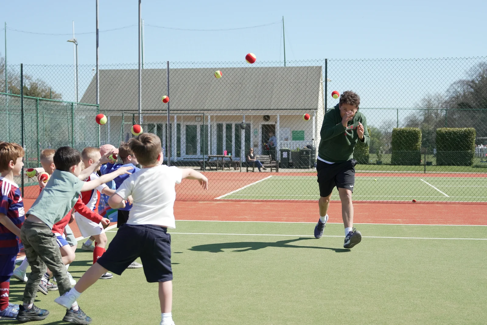 Children playing together during a Tennis by Sam birthday party on court